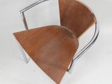an image of a wooden chair with chrome legs and a wooden seat