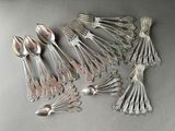 a lot of silver spoons and spoon spoons on a table