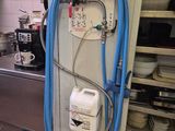 a blue hose attached to a wall in a kitchen