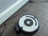a robot that is sitting on the floor next to a wall