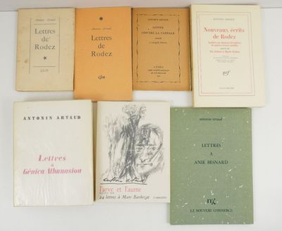several books are lined up on a white surface
