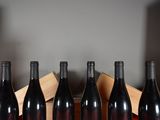 several bottles of wine are lined up in a row on a table