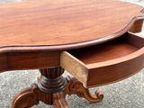 a wooden table with a drawer on top of it