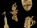 three gold - plated items including a mug, a statue, a statue of liberty and a statue of
