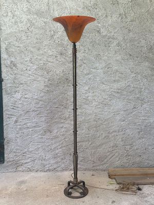 a floor lamp that is standing on a cement floor