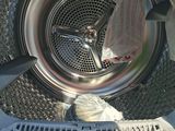 a close up of a washing machine with the door open