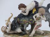 a figurine of a boy and a girl riding on a bull
