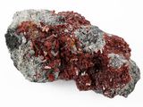 a close up of a rock with red crystals on it