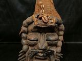 a wooden sculpture of a man with a hat on his head