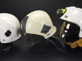 three helmets that are sitting on a black table