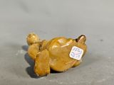 a small figurine of a dog with a tag on it