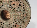 a close up of a metal object on a white surface