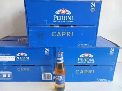 boxes of peroni capri beer are stacked on top of each other