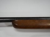 a close up of a rifle on a white surface