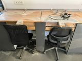 a desk with two chairs and a table with a computer on it