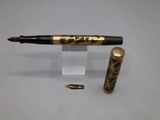 a pen and a bullet on a clear surface