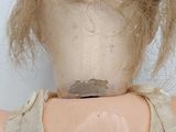 a close up of a doll that has a hair on it ' s head