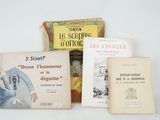 several books are sitting on a white surface with a white background