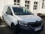 a white van that is parked in front of a building