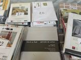 a lot of books and magazines on the table