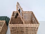 a wicker basket with a bottle of wine in it