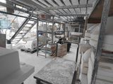 a room that has a lot of shelves and a table in it