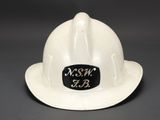a white hard hat with a black sticker on it