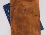 an image of a piece of brown paper on top of a blue and white table cloth