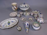 many different pieces of pottery sitting on a table