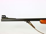 a rifle with a wooden barrel on a white background