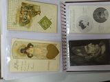 a hand holding a book with pictures of people on it
