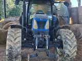 a tractor that is parked in a hay field