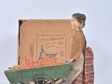 toy figurine of a woman pushing a cart of tomatoes