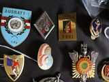 a lot of pins and badges on a black table