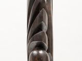 a wooden vase that is sitting on a white surface