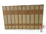 five books in a row on a white surface