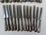 a lot of knives that are sitting on a table