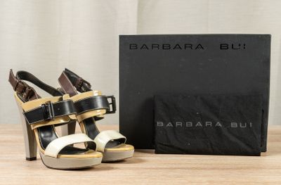a pair of shoes sitting on a table next to a box