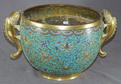 a large blue vase with a gold handle on a gray background