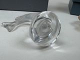 a glass animal figurine on a table with a box in the background