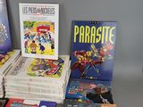a lot of comic books sitting on a table