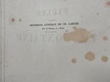 an old book with writing on it sitting on a table