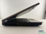 the laptop is open on a white table with a black keyboard