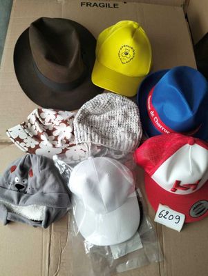 a cardboard box filled with hats and other items