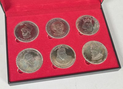 a red box with six coins in it on a table