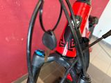 a close up of a bike handle with a red and black handlebar