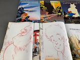 several children ' s books are lined up on a table