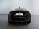 the rear of a black bmw vehicle in a white room