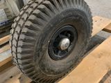 a large tire on a pallet in a warehouse