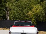 a red and white car parked on the side of the road